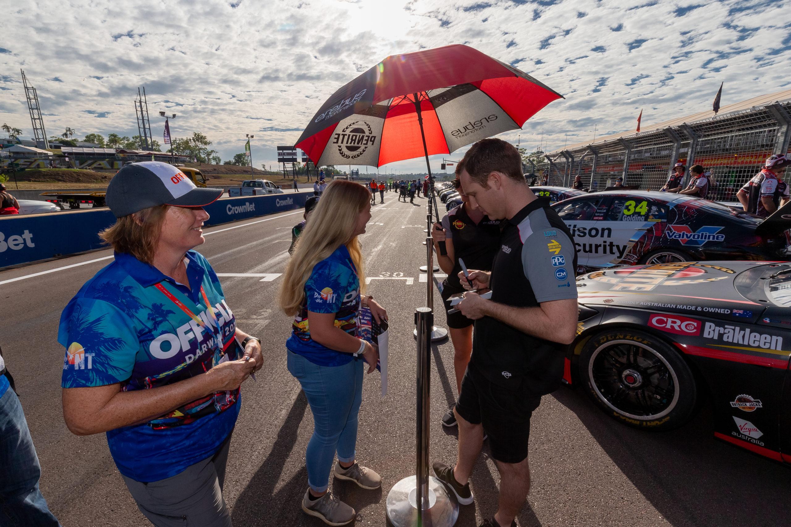 Supercar driver signing autographs