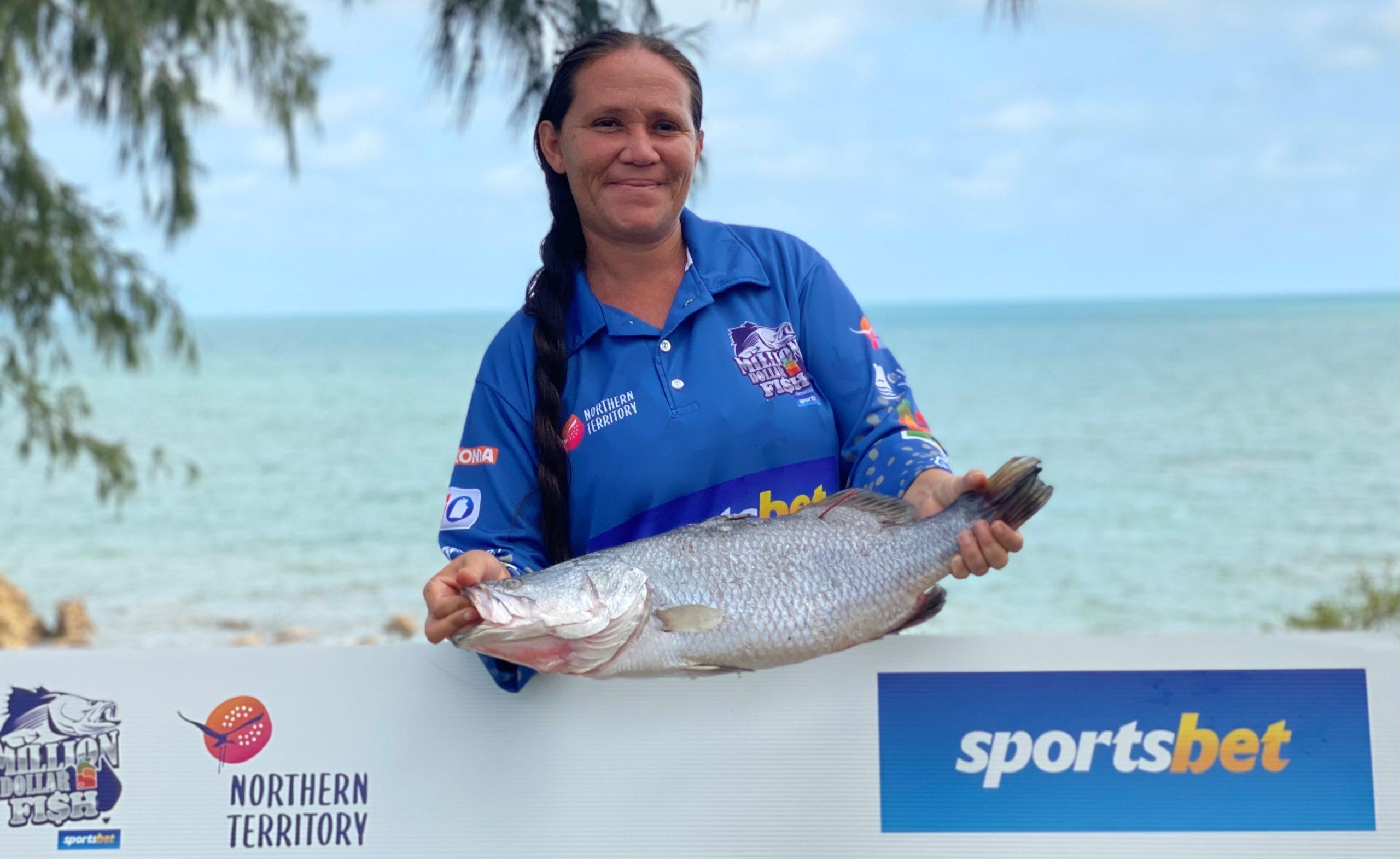 Million Dollar Fish winner holding up $10,000 barra